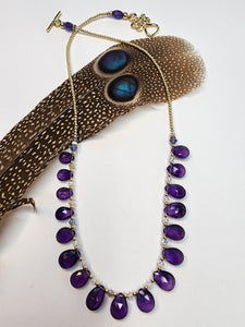 Tear drop Amethysts, graduated, faceted, with gold filled 2mm seamless beads and a gold vermillion Celtic toggle for closure.